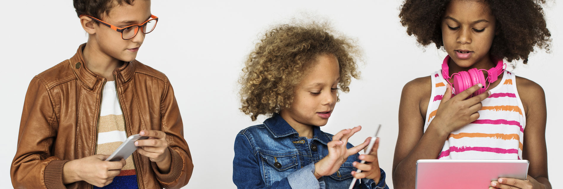 Children playng on tablets / phones